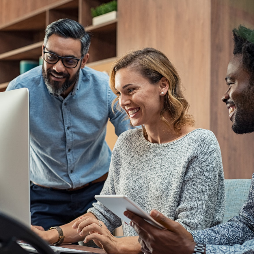 3 people working together on a computer