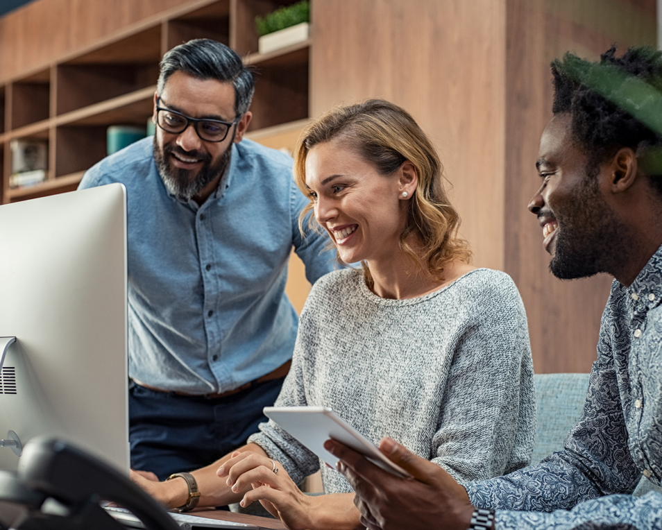 3 people working together on a computer