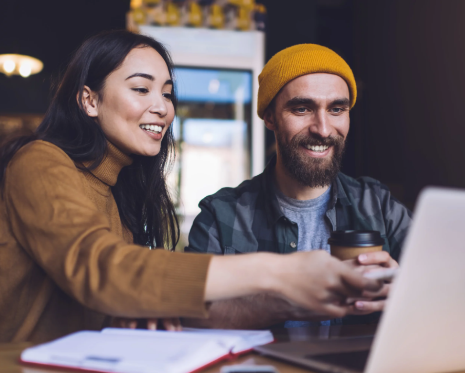 man and woman working on a laptop together